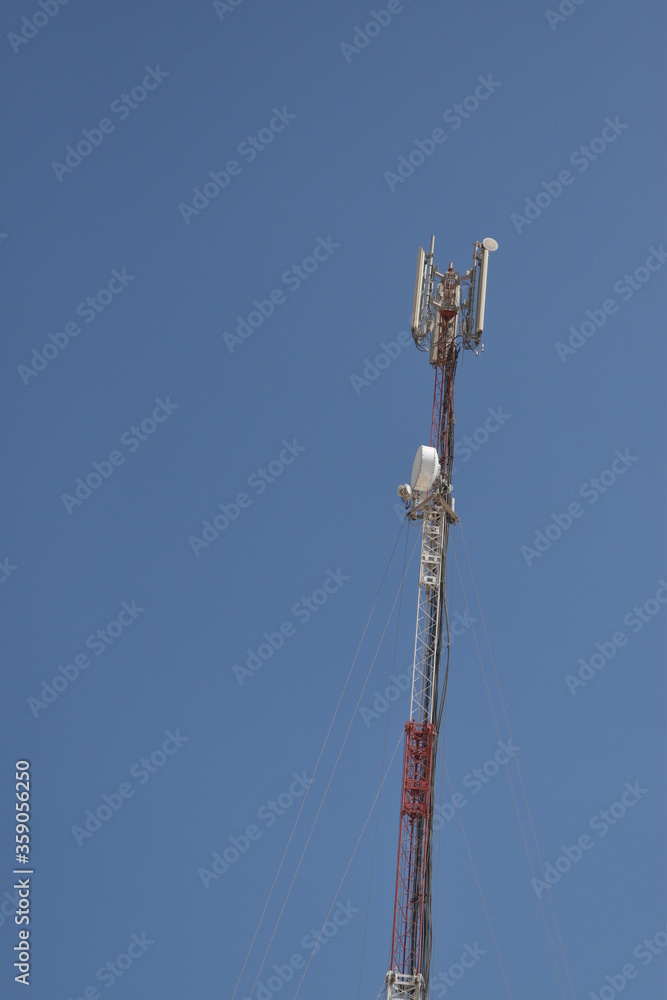 High telephone tower. Beautiful sky with a communications tower in the foreground.Abu dhabi,UAE.16.06.2020. High telephone tower. Beautiful sky with a communications tower in the foreground.Abu dhabi,UAE.16.06.2020.