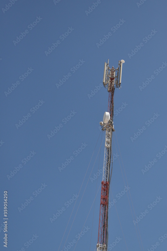 High telephone tower. Beautiful sky with a communications tower in the foreground.Abu dhabi,UAE.16.06.2020.