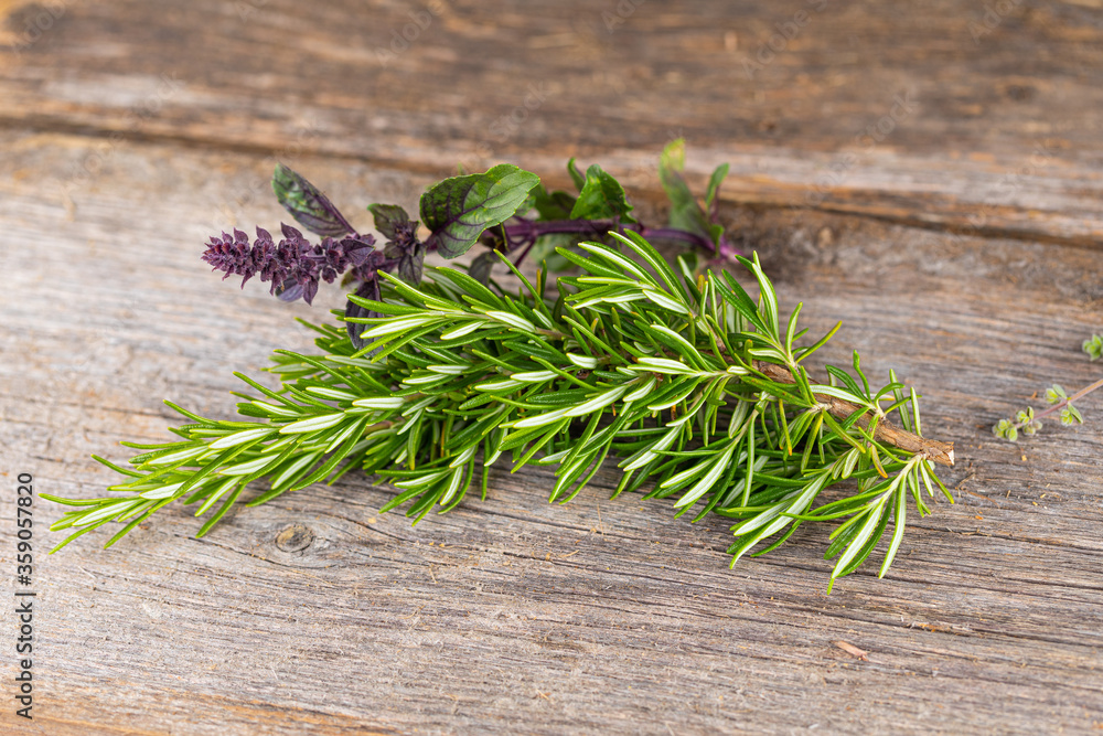herbs fresh from the garden - boquet of thyme, basil on an old wooden board herbs fresh from the garden - boquet of thyme, basil on an old wooden board