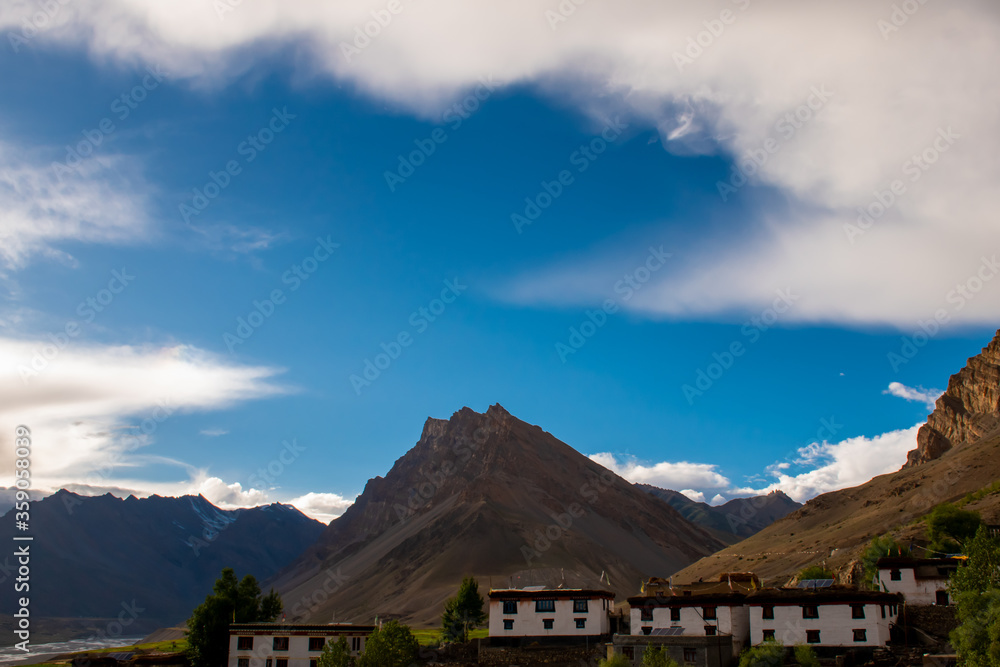mountain landscape with blue sky and small houses mountain landscape with blue sky and small houses