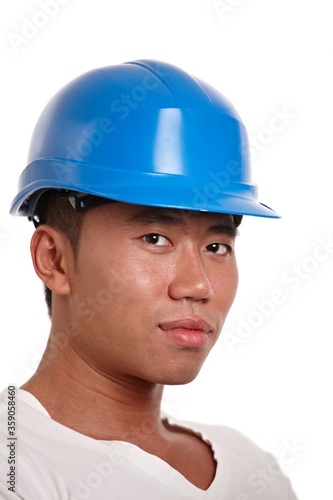 Portrait of young asian construction worker looking at camera, smiling, isolated on white. 