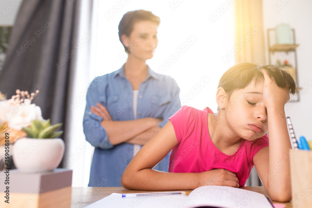 a mother not happy because her daughter does not do her school homework a mother not happy because her daughter does not do her school homework
