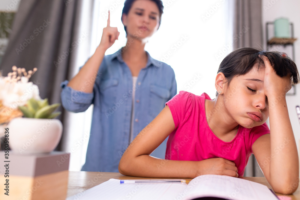 a mother not happy because her daughter does not do her school homework a mother not happy because her daughter does not do her school homework