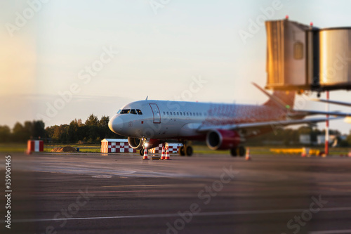 Colorful of sunset in the airport with aeroplane wing, Business and transportation concept.