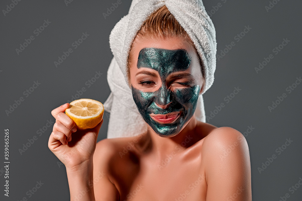 Beautiful woman with green peel-off mask on a gray background. Beautiful woman with green peel-off mask on a gray background.