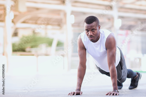 african american man is outdoor exercising by push up Look strong, clearly see the muscles in the upper arm