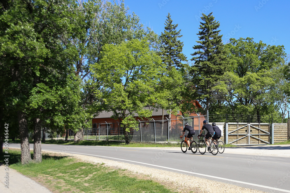 Winnipeg, Manitoba / Canada - June 13, 2020: Friends Cycling at Assiniboine Park.
