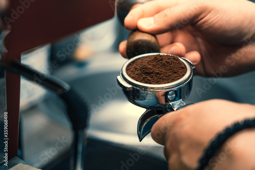  Steamed coffee machine, barista makes coffee in a cafe