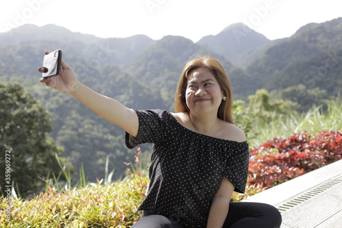 Young Filipina woman taking a selife