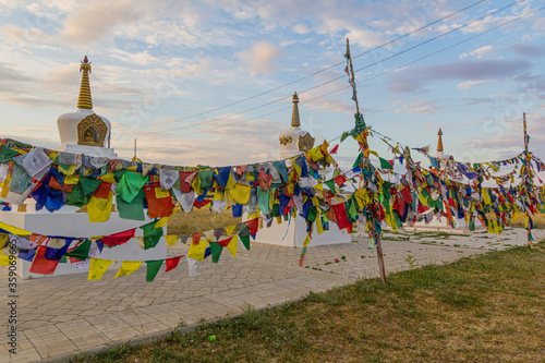 Stupas and flags near Syakusn Syume, Geden Sheddup Choikorling Monastery, Tibetan Buddhist monastery in Elista, Republic of Kalmykia, Russia photo