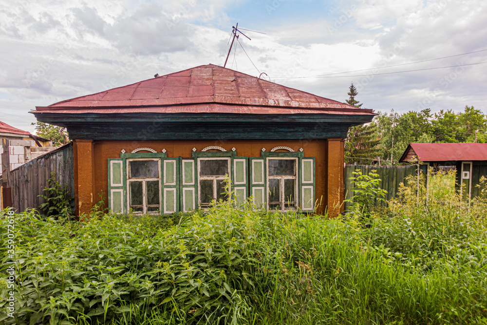 Typical old Russian wooden house in Tyumen city, Russia