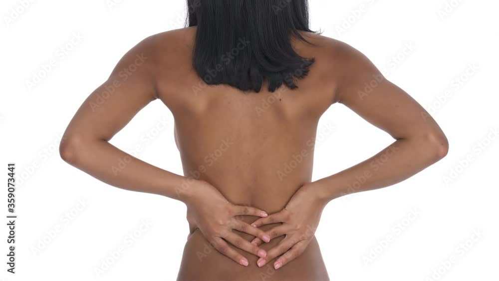 Back view of a black woman having problems with the spine. Osteoporosis leading the back pain. Healthcare concept. Isolated one the white background. Back view of a black woman having problems with the spine. Osteoporosis leading the back pain. Healthcare concept. Isolated one the white background.