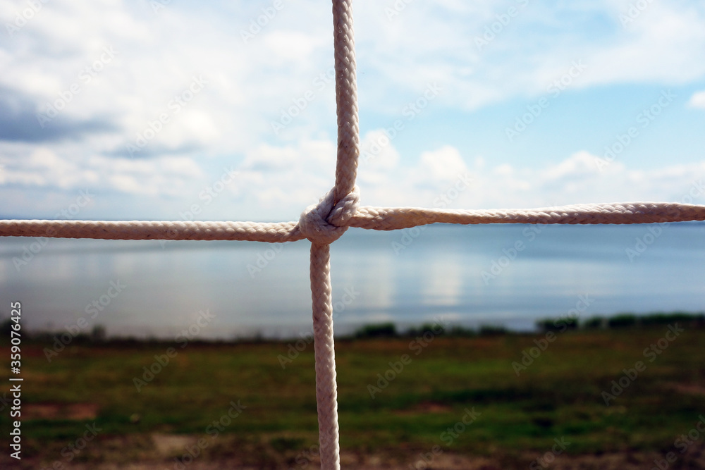 Rope fence and blurred background with the lake shore