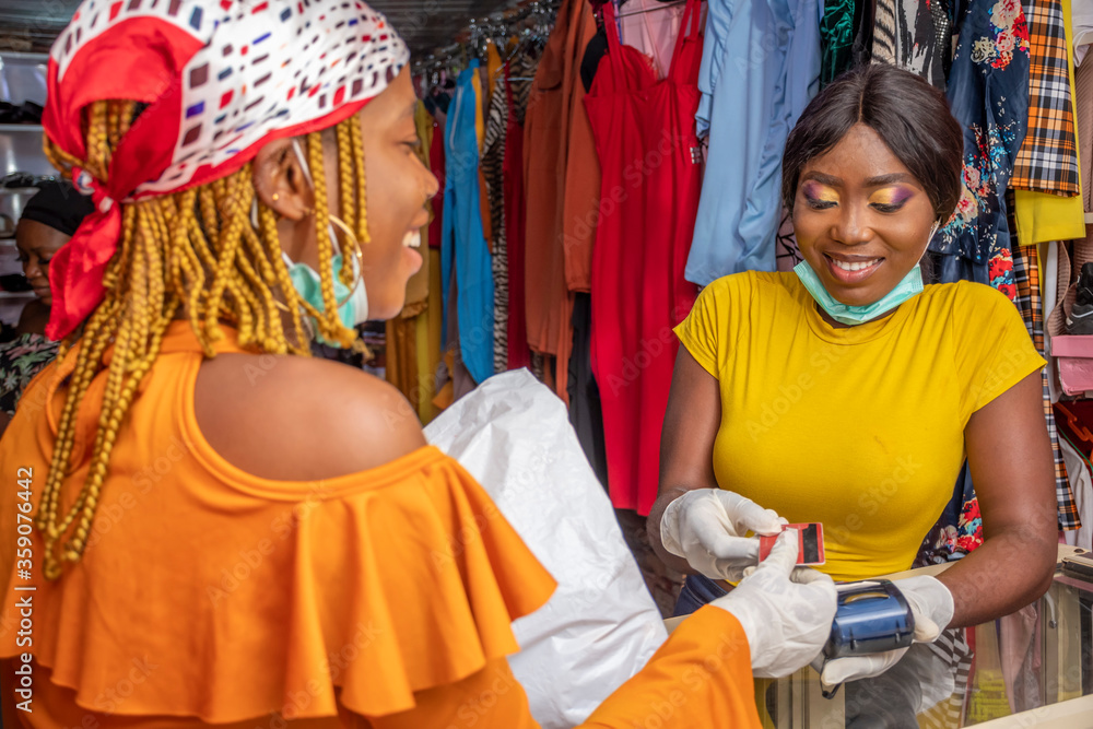 african business woman collecting a credit card from a customer