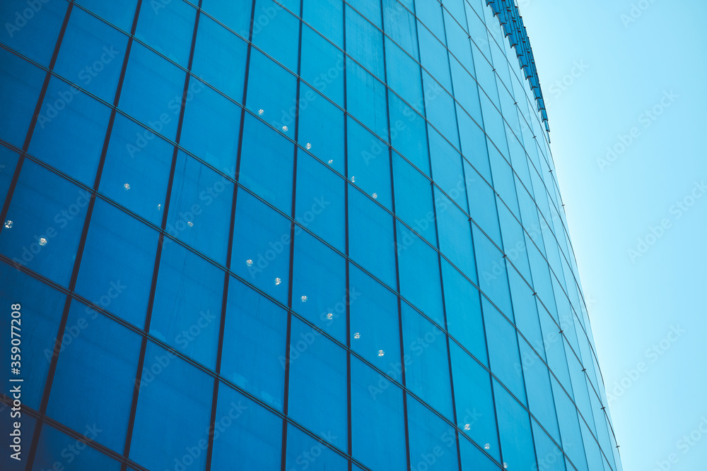 Business class modern glass building against the sky with toned Business class modern glass building against the sky with toned