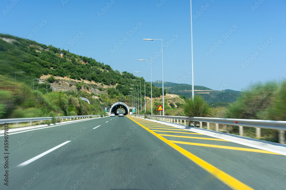 Fototapeta premium the road in front of the tunnel. road in motion