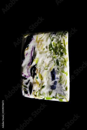 colored soap on a black background