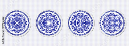 Set of four plates with a stylized blue floral pattern made in Russian folk style Gzhel