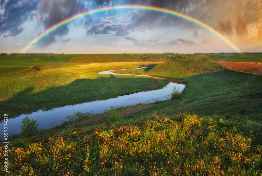 Naklejka premium Landscape with a Rainbow on the River in Spring