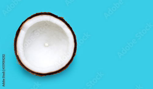 Half Coconut on blue background.