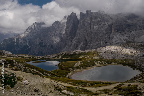 Dolomites Alps. Lago dei Piani. Italy. Two alpine lakes on background of dolomite grey peak Crode dei Piani mountain wrapped by white clouds. Desert view