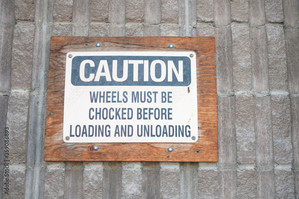 Sign at loading dock to ensure trucks are loaded safely Sign at loading dock to ensure trucks are loaded safely