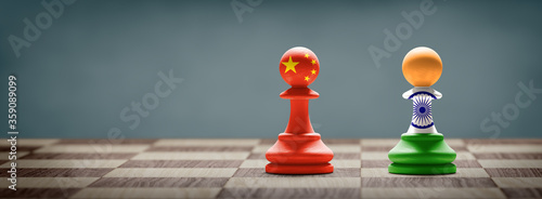 China and India conflict. Country flags on chess pawns on a chess board. 3D illustration.