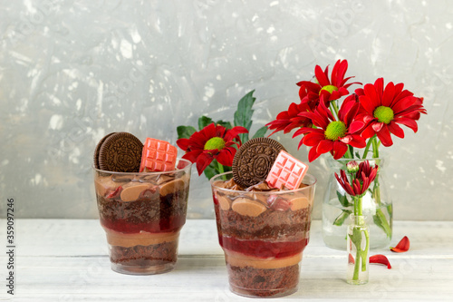 Two delicious chocolate desserts with strawberries  jam, caramel and chocolate cream .