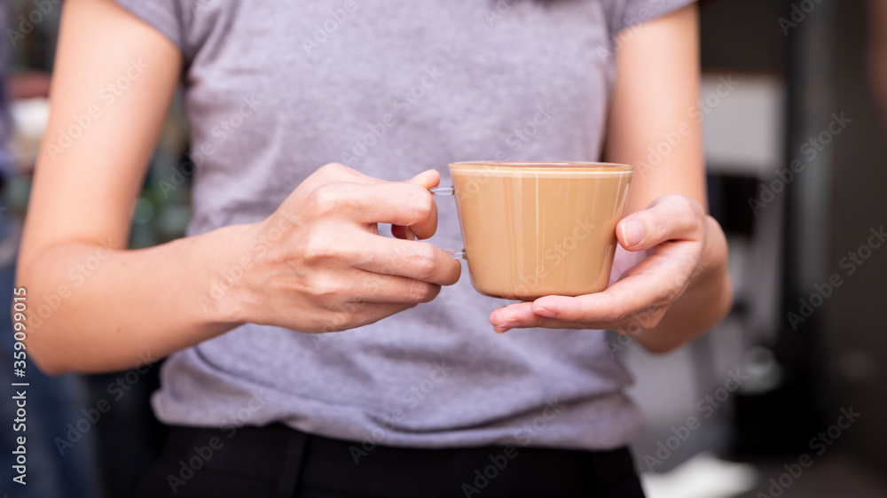 woman holding cup of coffee