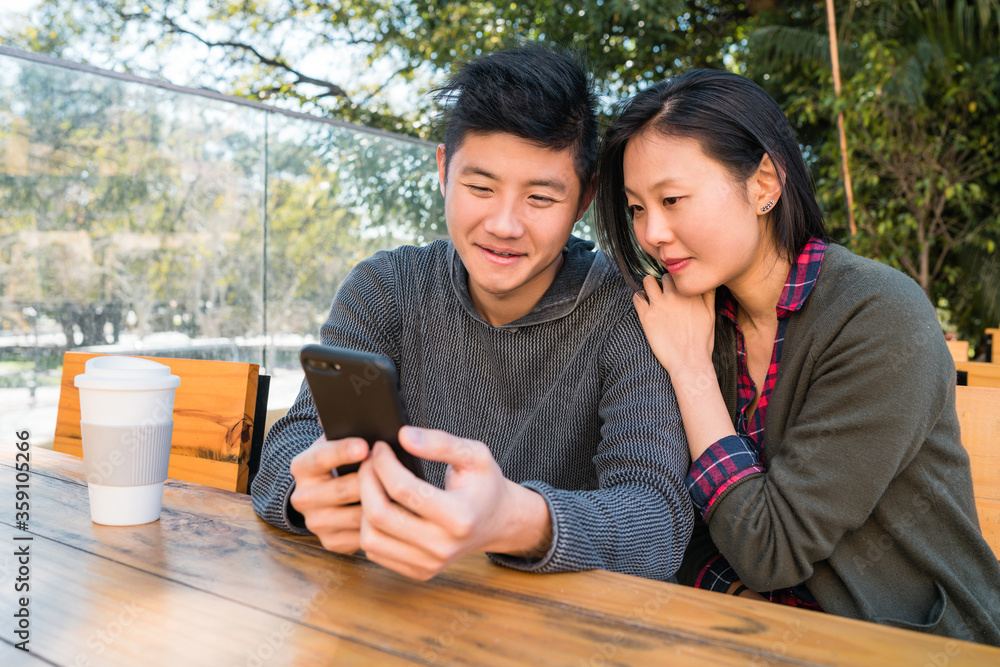 Asian couple looking at the mobile phone. Asian couple looking at the mobile phone.