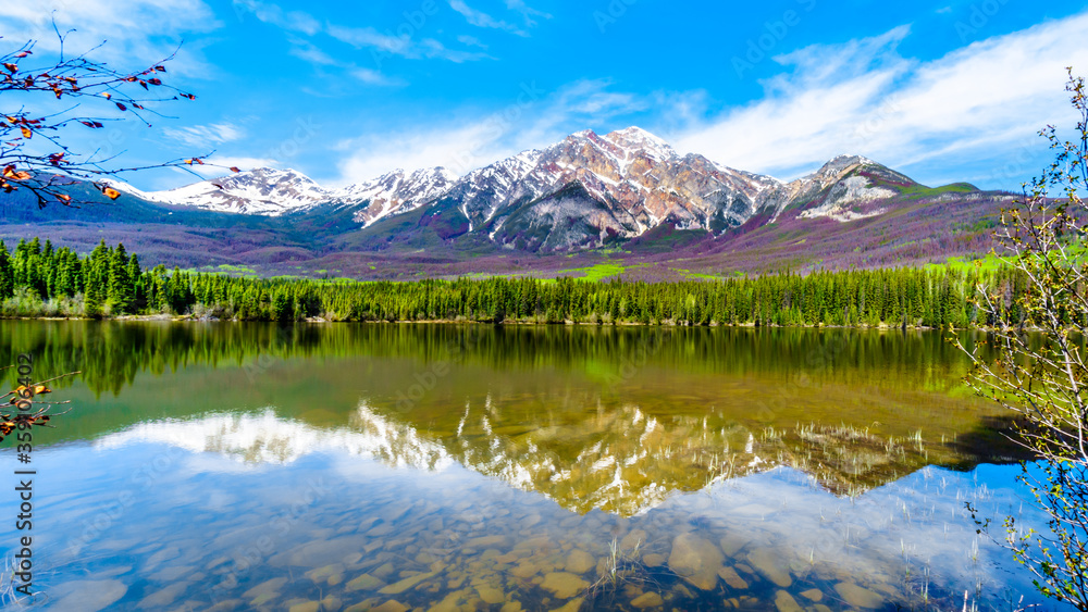 Reflection of Pyramid Mountain in Pyramid Lake in Jasper National Park in Alberta, Canada. The mountains is part of the Victoria Cross Range in the Rocky Mountains