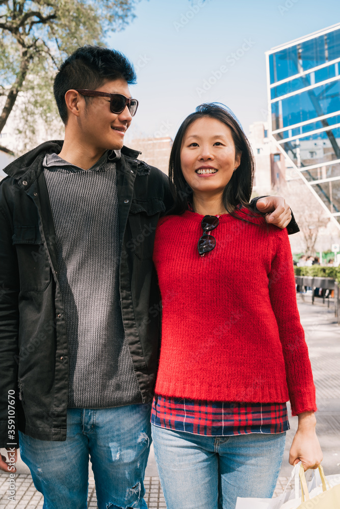 Asian couple walking in the city.