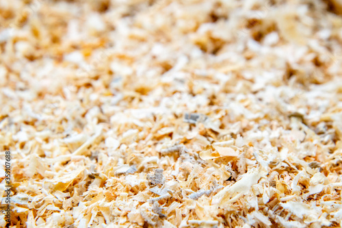 Close up view to light brown wooden shavings. Natural background. Different sawdust
