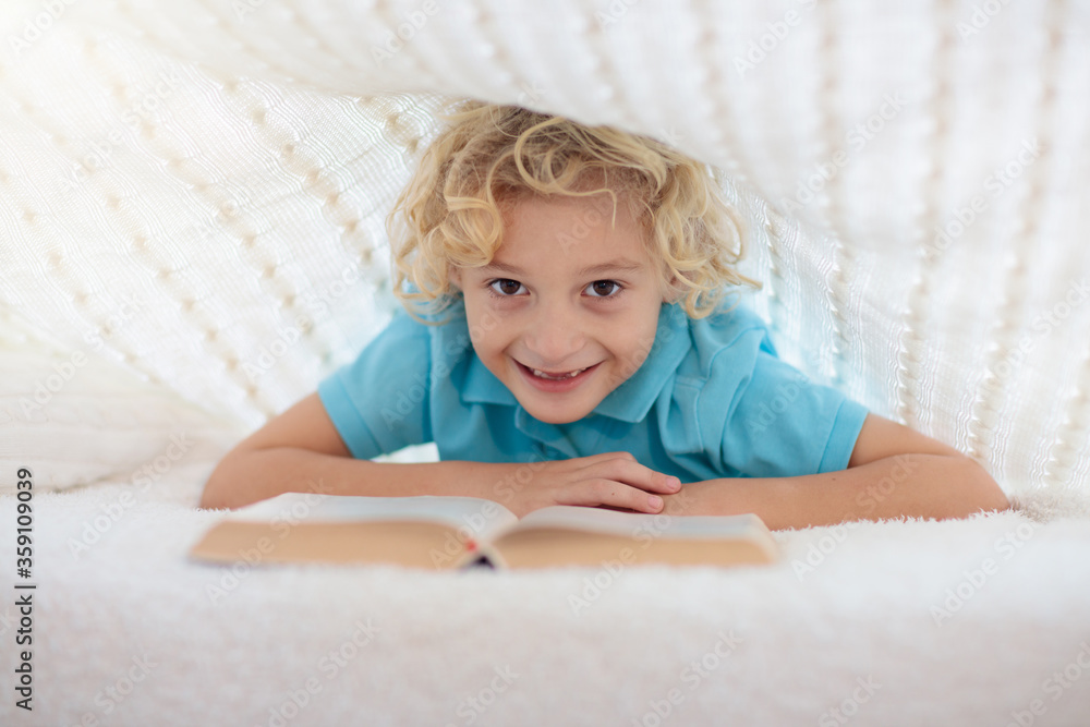 Child reading book in bed. Kids read books. Child reading book in bed. Kids read books.