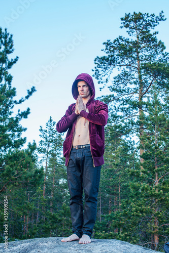 young attractive guy in woods alone practicing sport activity  lifestyle people concept