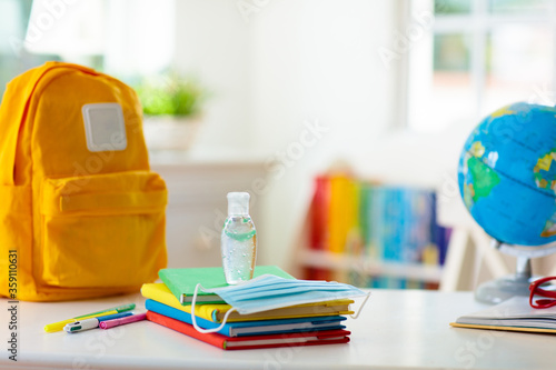 Backpack of school child. Face mask and sanitizer.
