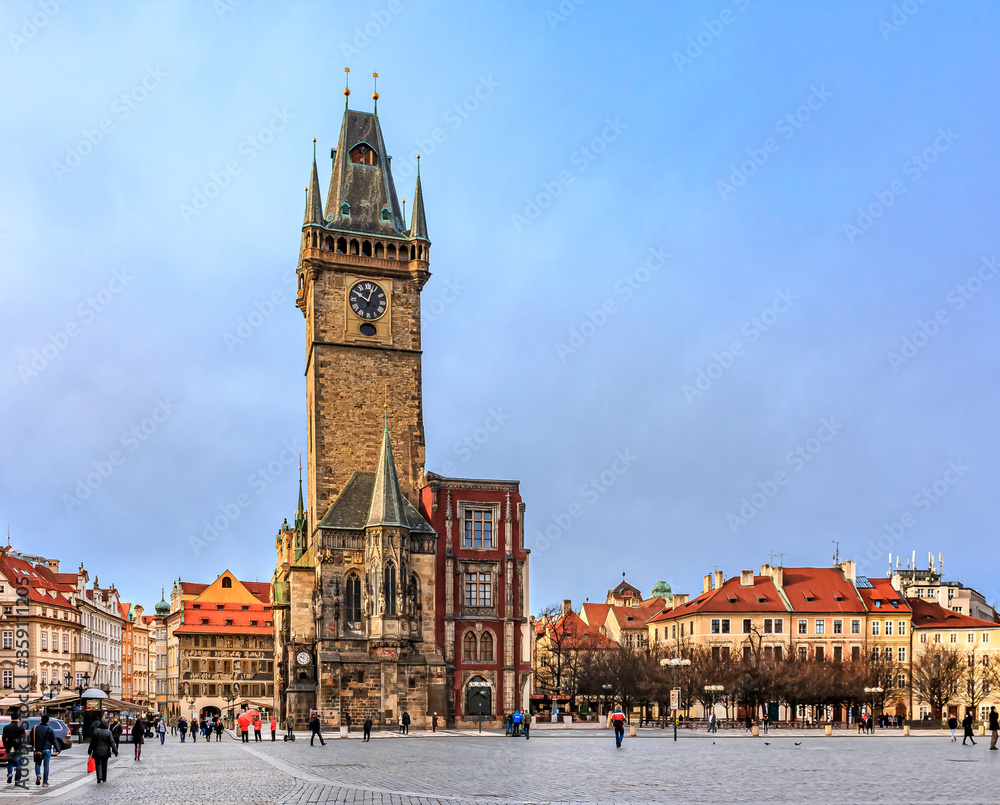 Panorama of the Old Town Square with Old Town Hall Clock Tower in the center and people walking in the street of Prague, Czech Republic 
