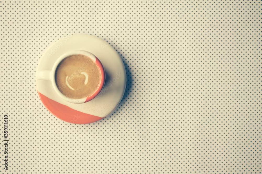 Freshly brewed sparkling coffee in a small orange and white mug. Cup with typical Brazilian drink on a wooden board. Copy space. Freshly brewed sparkling coffee in a small orange and white mug. Cup with typical Brazilian drink on a wooden board. Copy space.