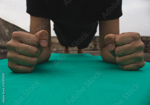 Self-portrait of a Young man doing Yoga at his rooftop in isolation during Covid-19 lock down. photo