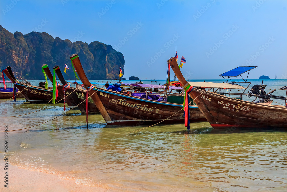 ongtail boats docked at the beautiful Ao Nang beach in Krabi Thailand
