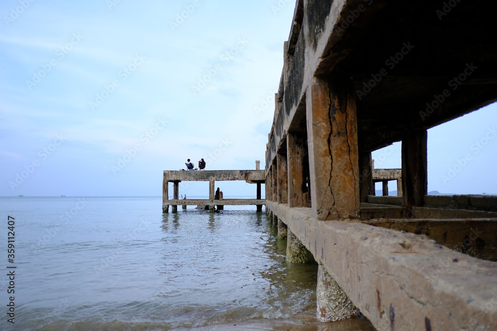 landscape photography of concrete bridge leading to the sea photo