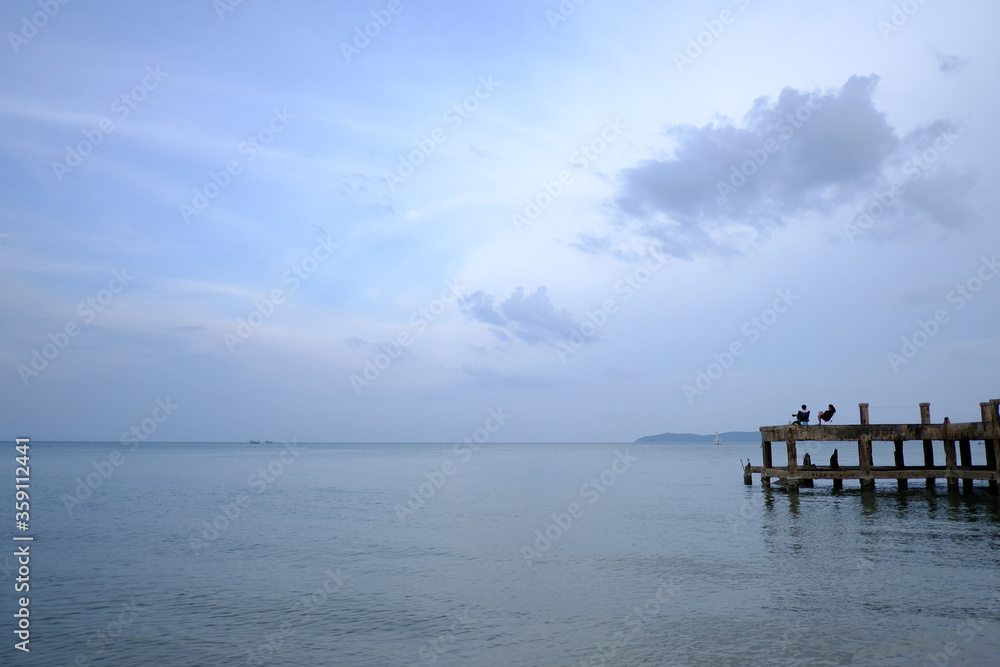 landscape photography of concrete bridge leading to the sea photo in Haadson Beach thailand