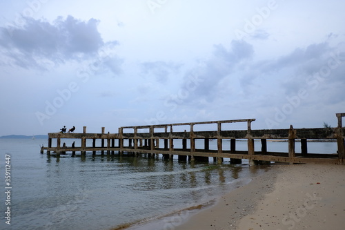 landscape photography of concrete bridge leading to the sea photo in Haadson Beach thailand