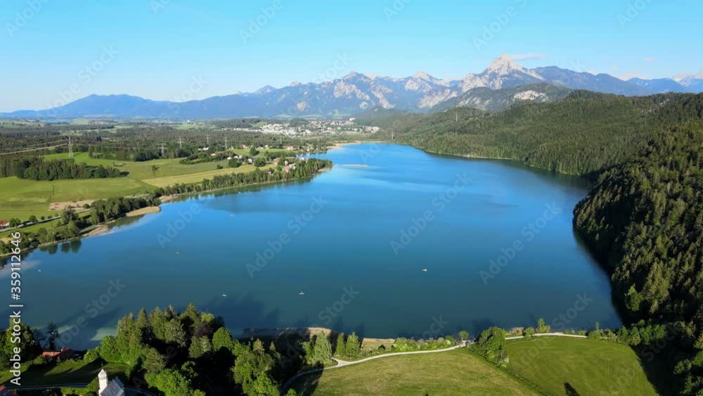 Lake Weissensee in Bavaria - beautiful small lake in the Allgau district - aerial drone footage Lake Weissensee in Bavaria - beautiful small lake in the Allgau district - aerial drone footage