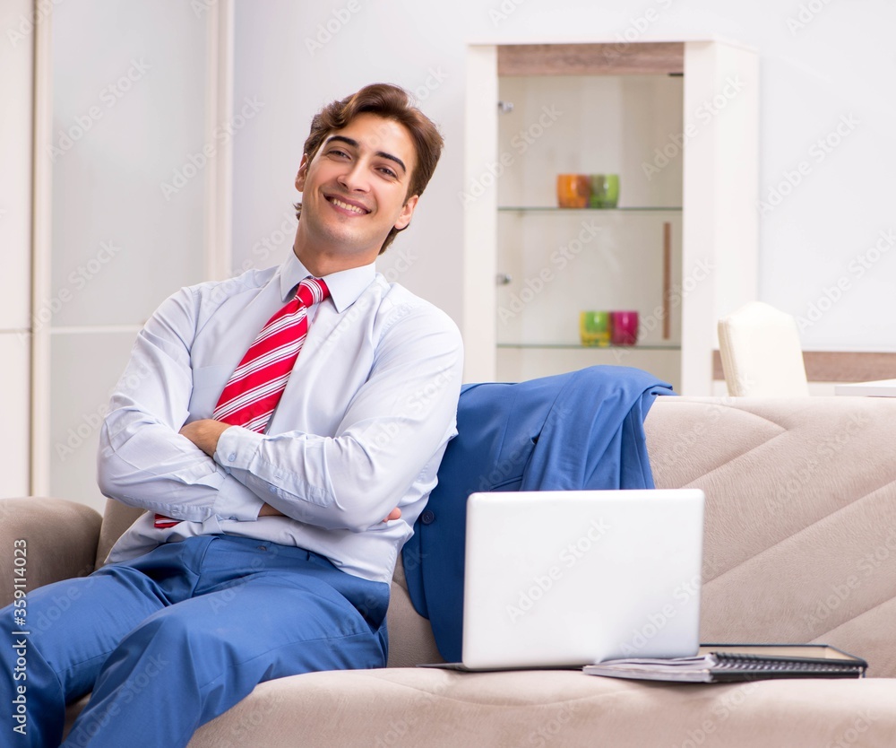 Young businessman working at home sitting on the sofa Young businessman working at home sitting on the sofa