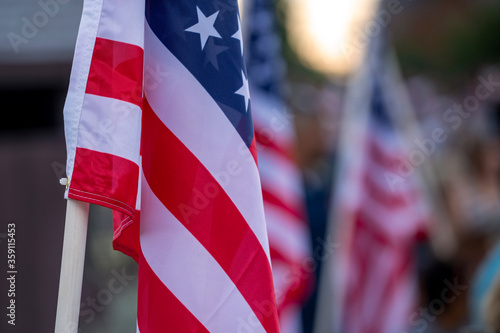 A closeup photo shows American flags flying on the 4th of July.