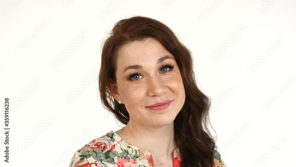 Beautiful redhead Caucasian young woman with healthy clean skin with freckles looking at the camera with smile. Beautiful redhead Caucasian young woman with healthy clean skin with freckles looking at the camera with smile.