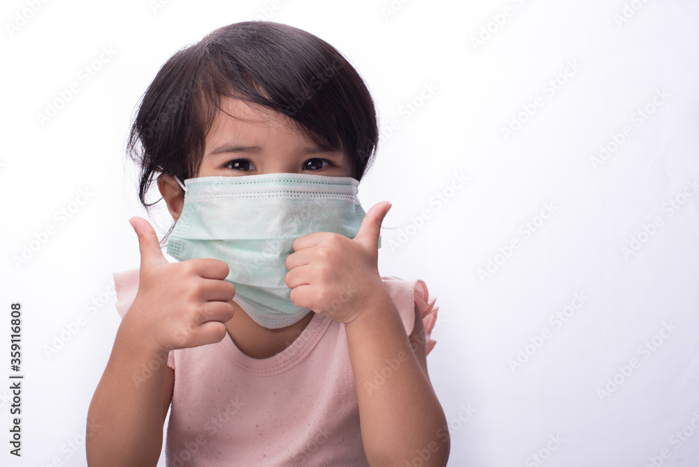 A female child wearing oversize medical face mask,isolated over white