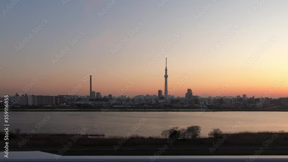 Train window with a clear view of Tokyo's evening sky Train window with a clear view of Tokyo's evening sky