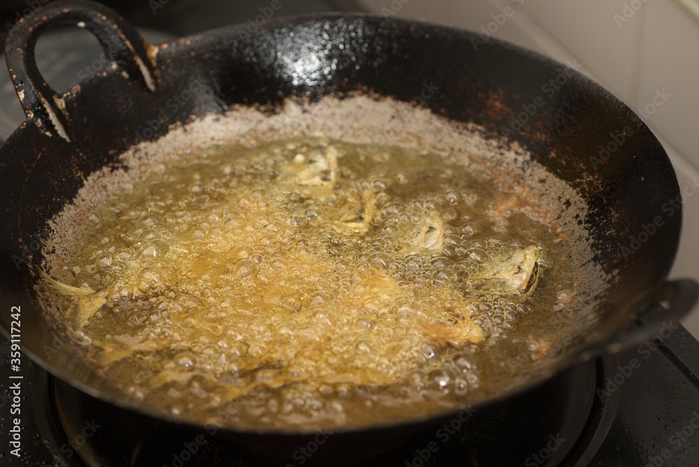 Fish being cooked in a pan Fish being cooked in a pan